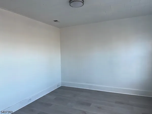 a view of hallway with wooden floor