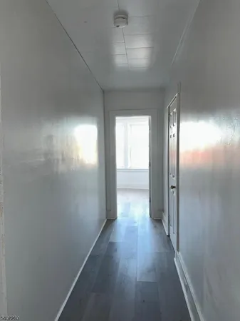 an empty room with wooden floor