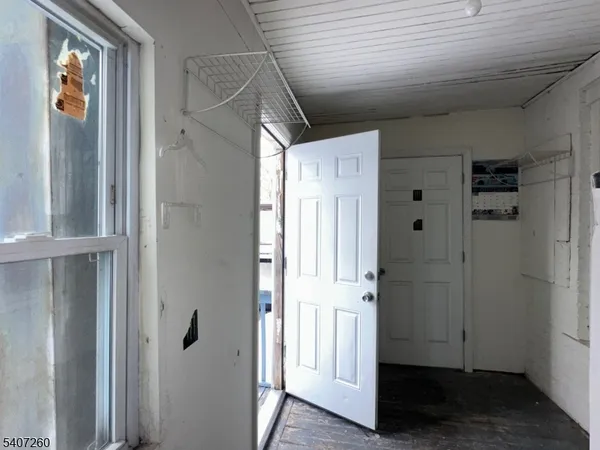 a view of a backyard with a tree and wooden fence