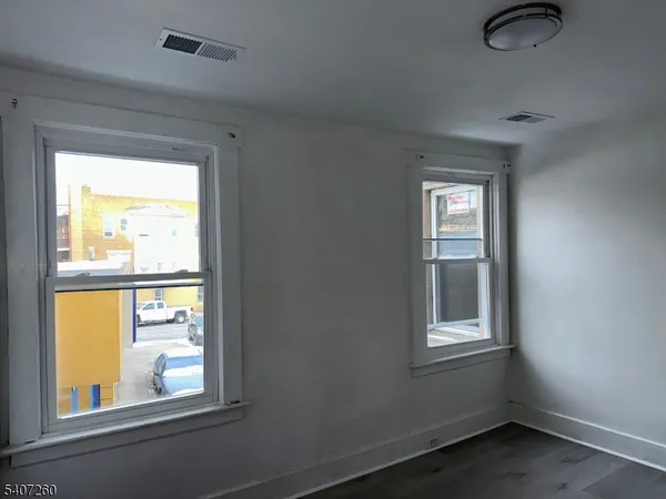 a kitchen with granite countertop a stove a sink and a refrigerator