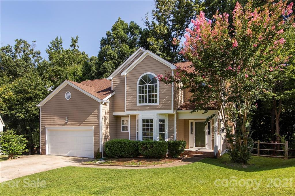 3518 Rindle Court Charlotte, NC 28269 - Photo 2 of 21 a front view of a house with a yard and trees