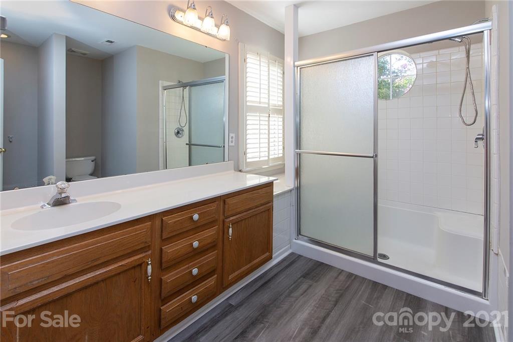 3518 Rindle Court Charlotte, NC 28269 - Photo 12 of 21 a bathroom with a double vanity sink and mirror
