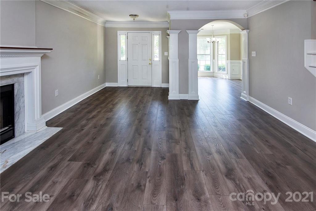 3518 Rindle Court Charlotte, NC 28269 - Photo 3 of 21 a view of a room with wooden floor and fireplace