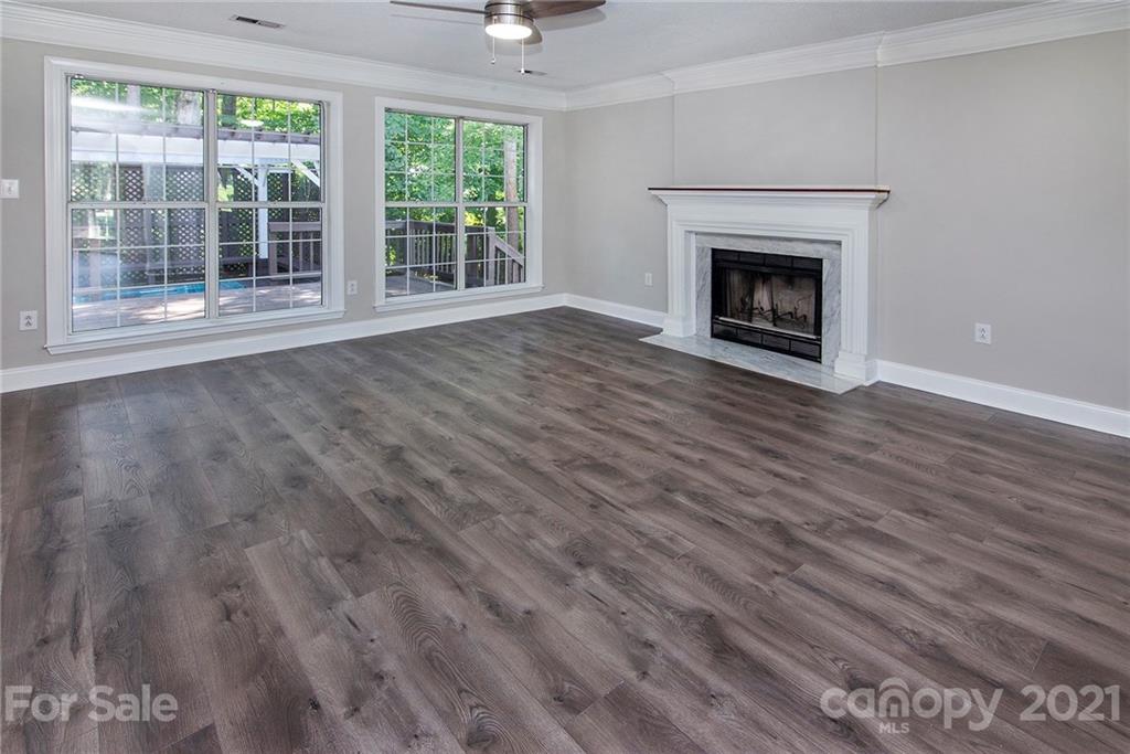 3518 Rindle Court Charlotte, NC 28269 - Photo 5 of 21 a view of an empty room with wooden floor fireplace and a window