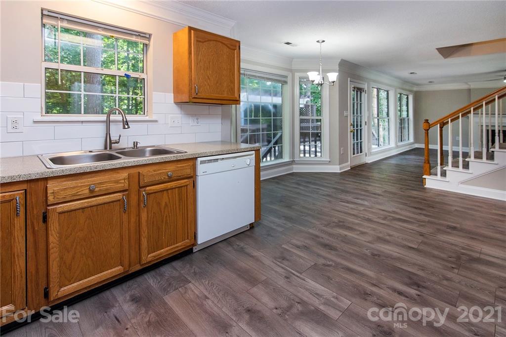 3518 Rindle Court Charlotte, NC 28269 - Photo 6 of 21 a kitchen with stainless steel appliances granite countertop a sink cabinets and wooden floor