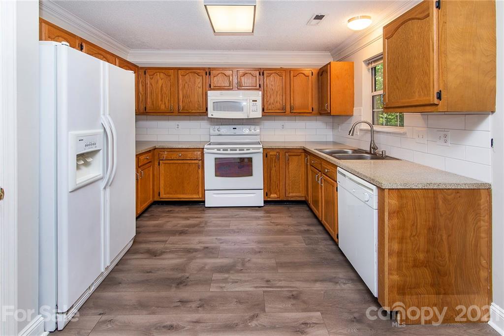 3518 Rindle Court Charlotte, NC 28269 - Photo 8 of 21 a kitchen with stainless steel appliances granite countertop a refrigerator sink and stove