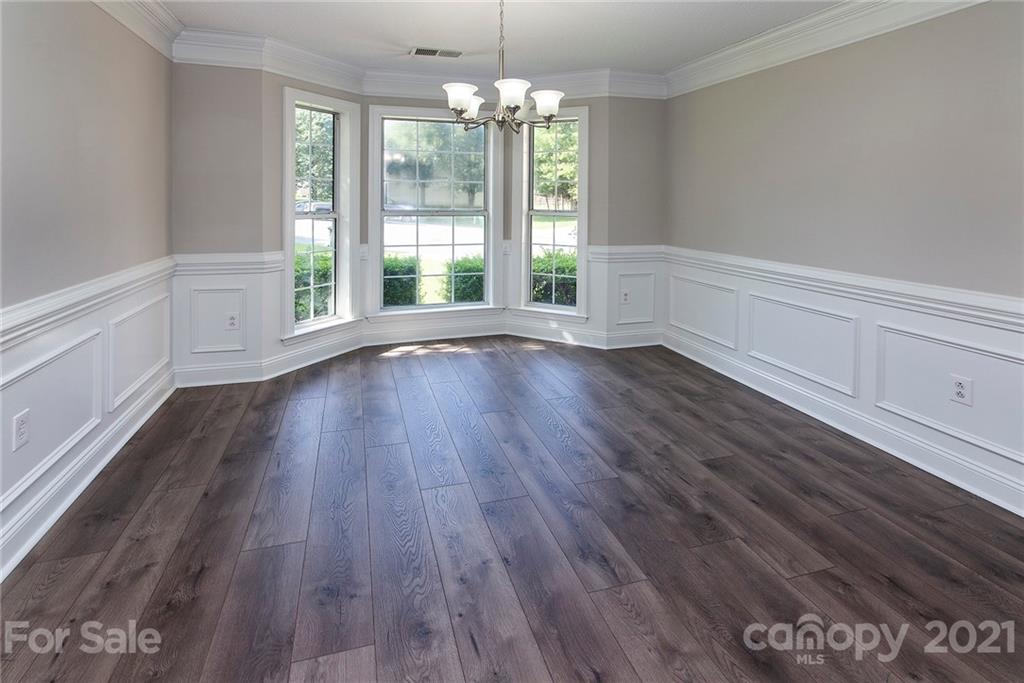 3518 Rindle Court Charlotte, NC 28269 - Photo 9 of 21 a view of an empty room with wooden floor and a window
