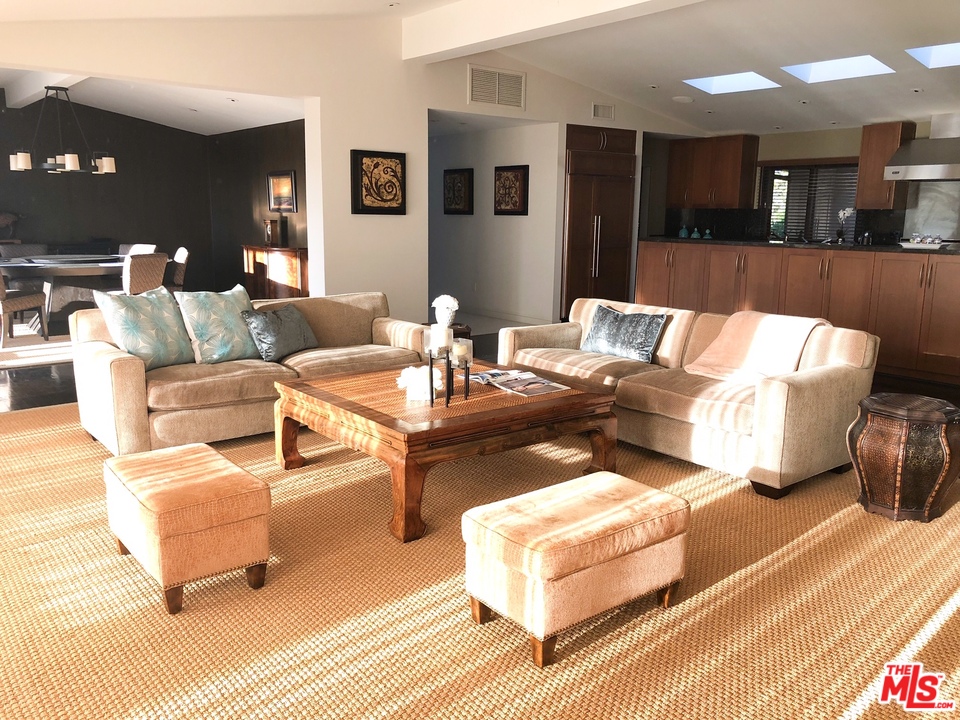 410 Walker Drive Beverly Hills, CA 90210 - Photo 13 of 36 a living room with furniture and a table