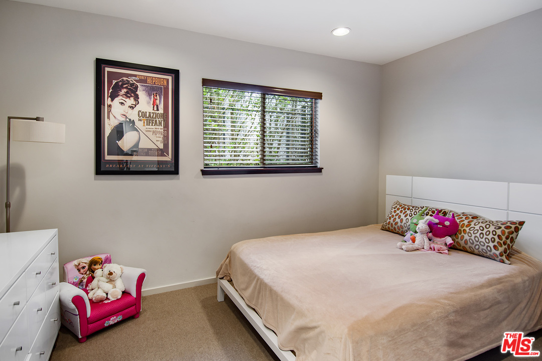 410 Walker Drive Beverly Hills, CA 90210 - Photo 18 of 36 a bedroom with a bed and a window