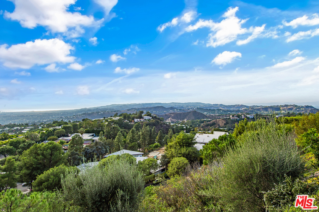 410 Walker Drive Beverly Hills, CA 90210 - Photo 3 of 36 a view of a city with lush green forest