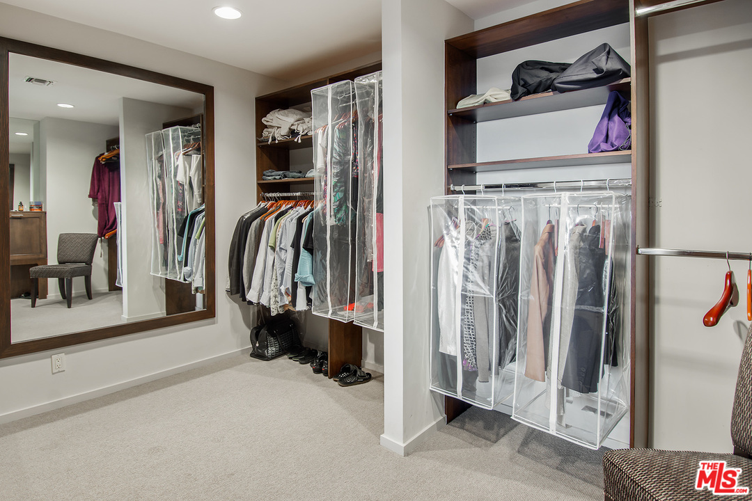 410 Walker Drive Beverly Hills, CA 90210 - Photo 22 of 36 a view of walk in closet with clothes and shoes