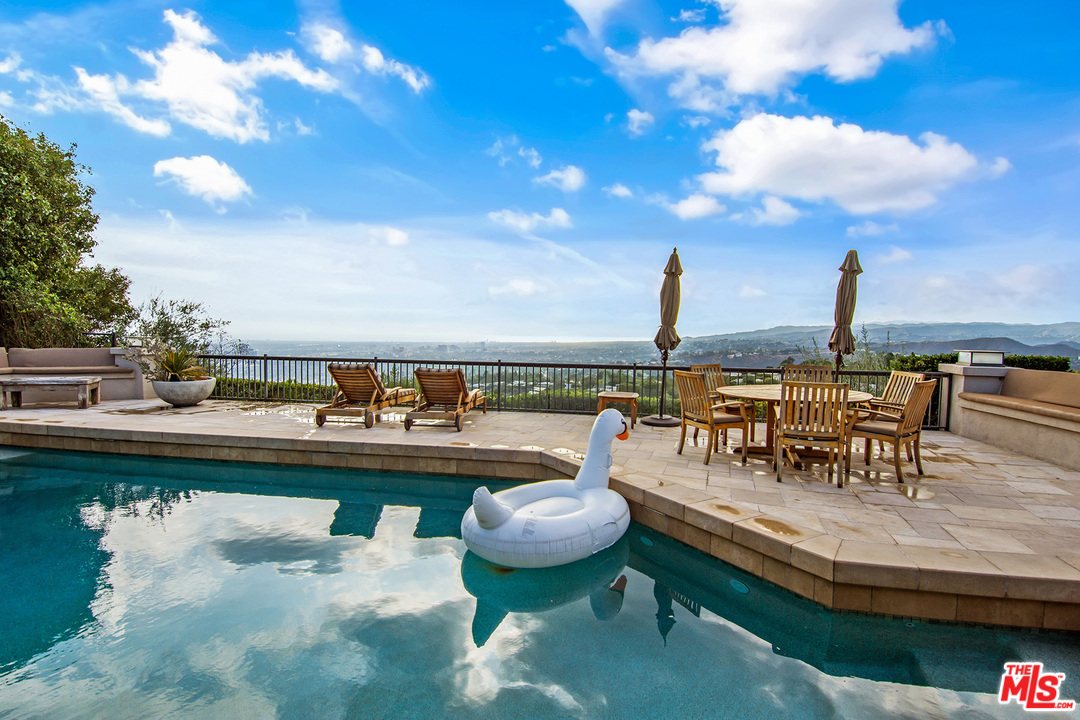 410 Walker Drive Beverly Hills, CA 90210 - Photo 28 of 36 a view of a swimming pool with outdoor seating