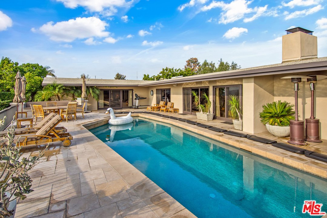410 Walker Drive Beverly Hills, CA 90210 - Photo 30 of 36 a view of a house with pool and chairs