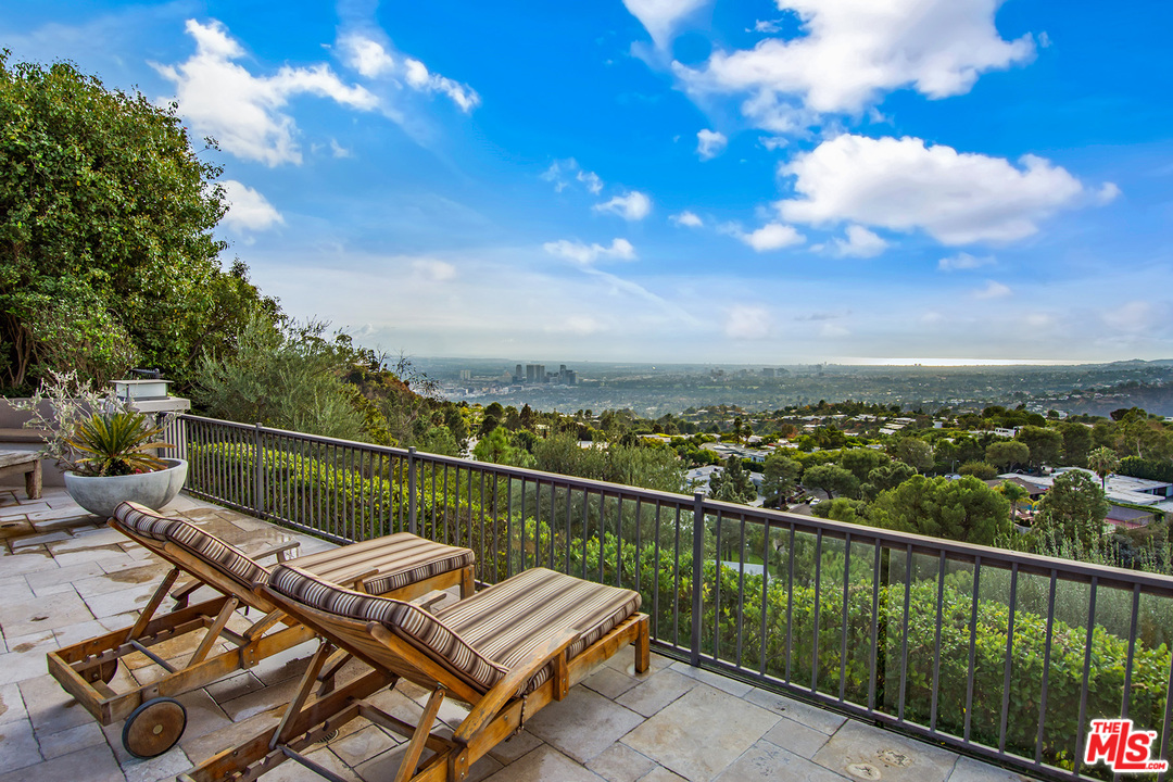 410 Walker Drive Beverly Hills, CA 90210 - Photo 31 of 36 a view of a balcony with wooden floor and city view