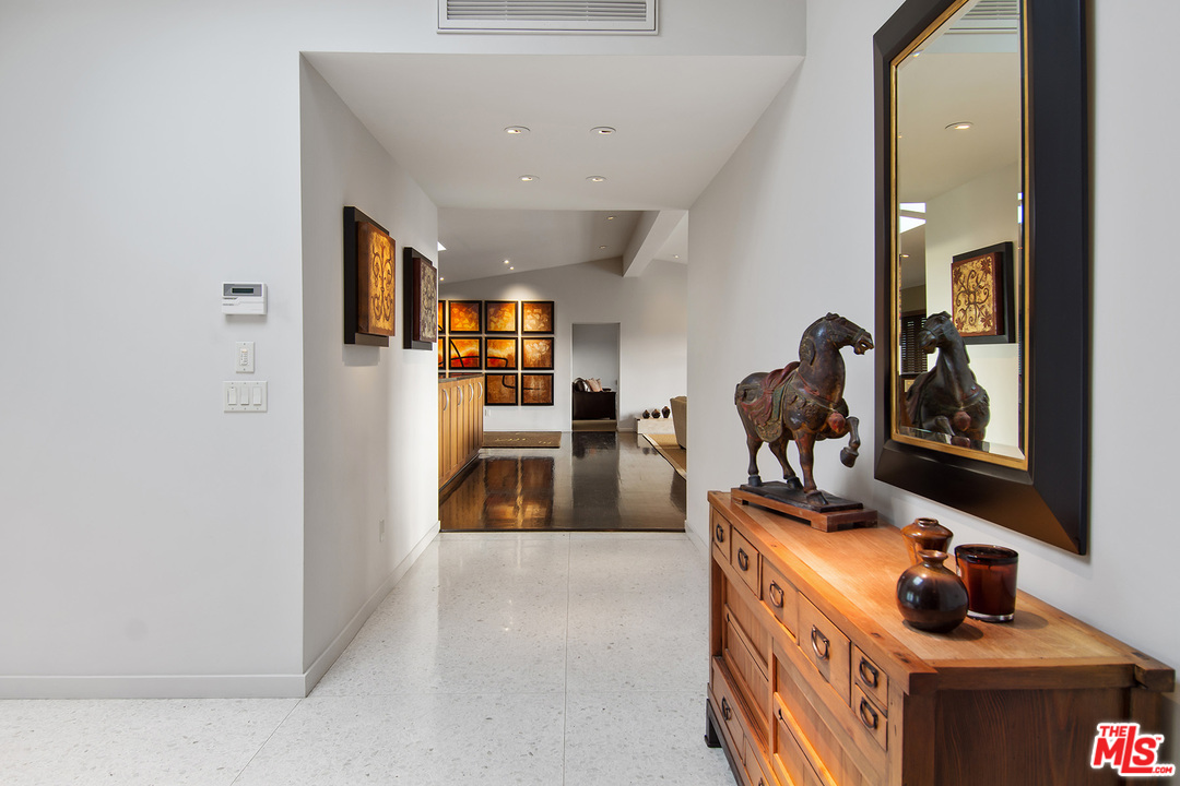 410 Walker Drive Beverly Hills, CA 90210 - Photo 7 of 36 a living room with furniture and a flat screen tv
