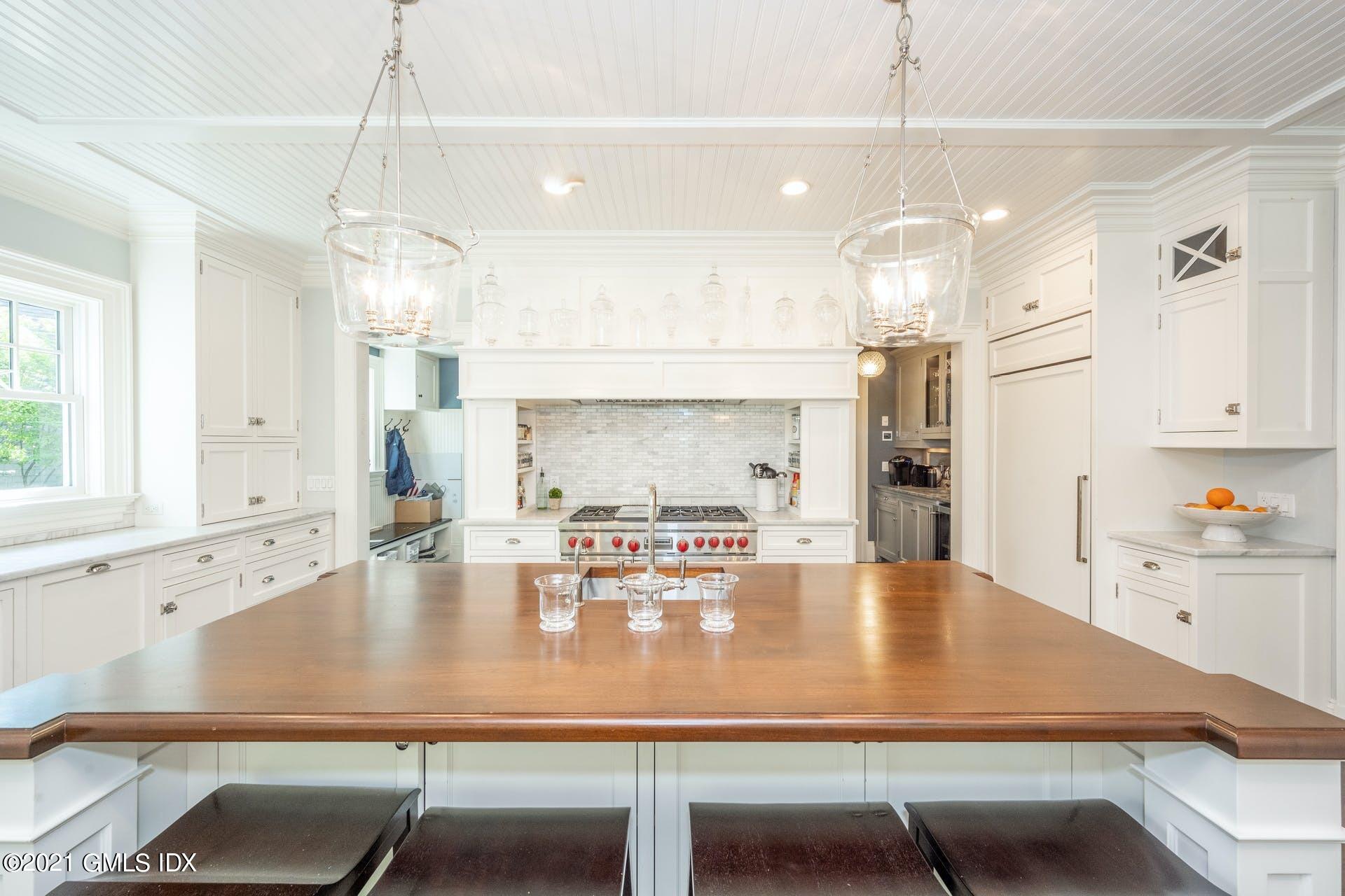 45 Willow Road Riverside, CT 06878 - Photo 13 of 38 a kitchen with kitchen island a table and chairs in it