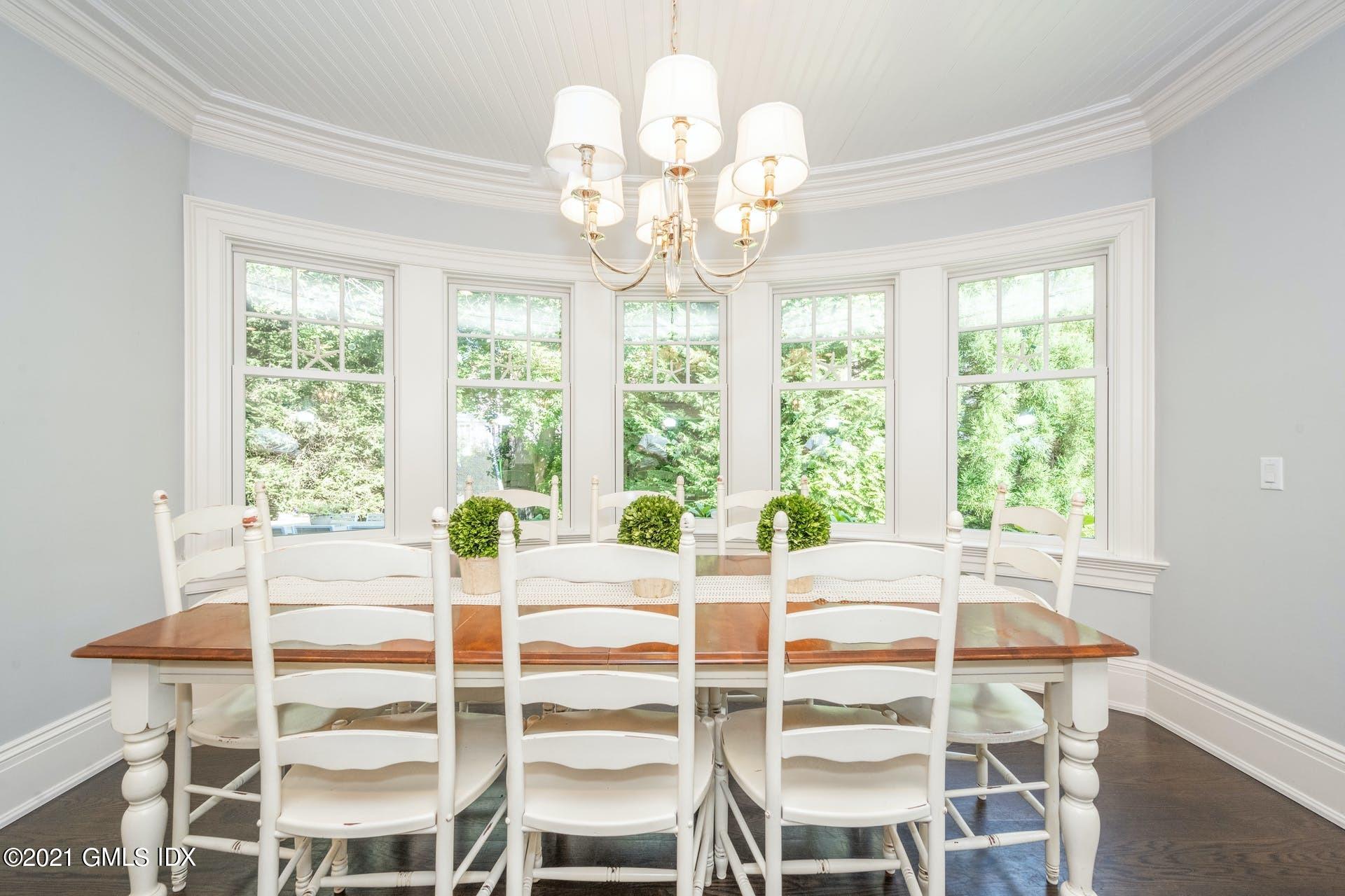 45 Willow Road Riverside, CT 06878 - Photo 14 of 38 a view of a dining room with furniture a chandelier and wooden floor