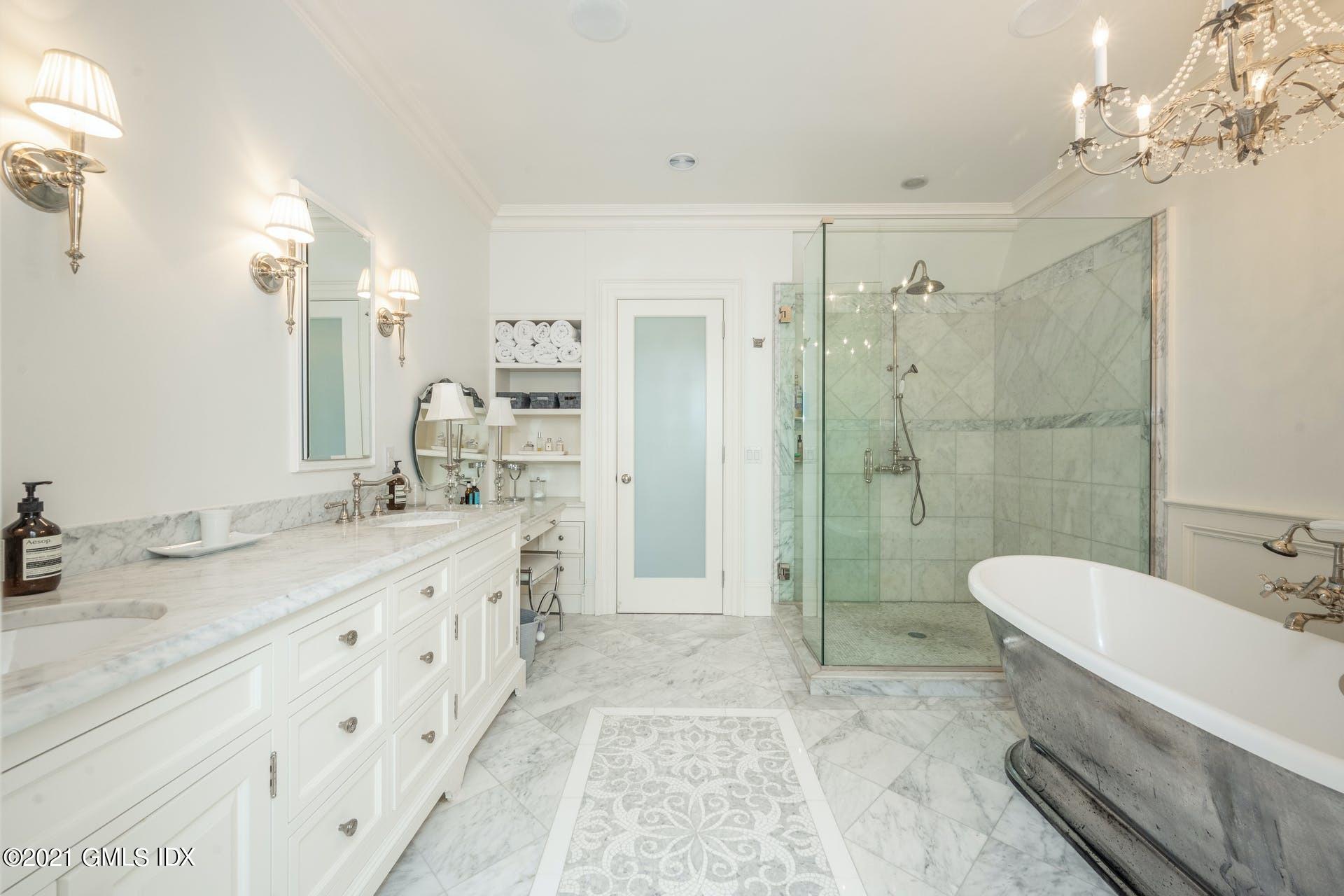 45 Willow Road Riverside, CT 06878 - Photo 20 of 38 a spacious bathroom with a granite countertop sink a toilet a mirror and shower