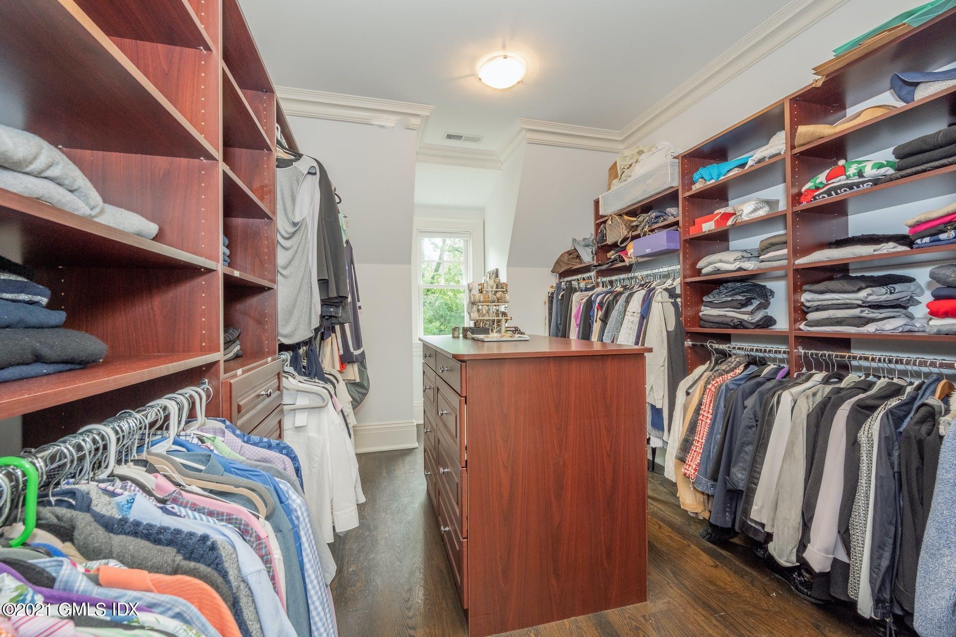 45 Willow Road Riverside, CT 06878 - Photo 22 of 38 a view of walk in closet with clothes and shoes