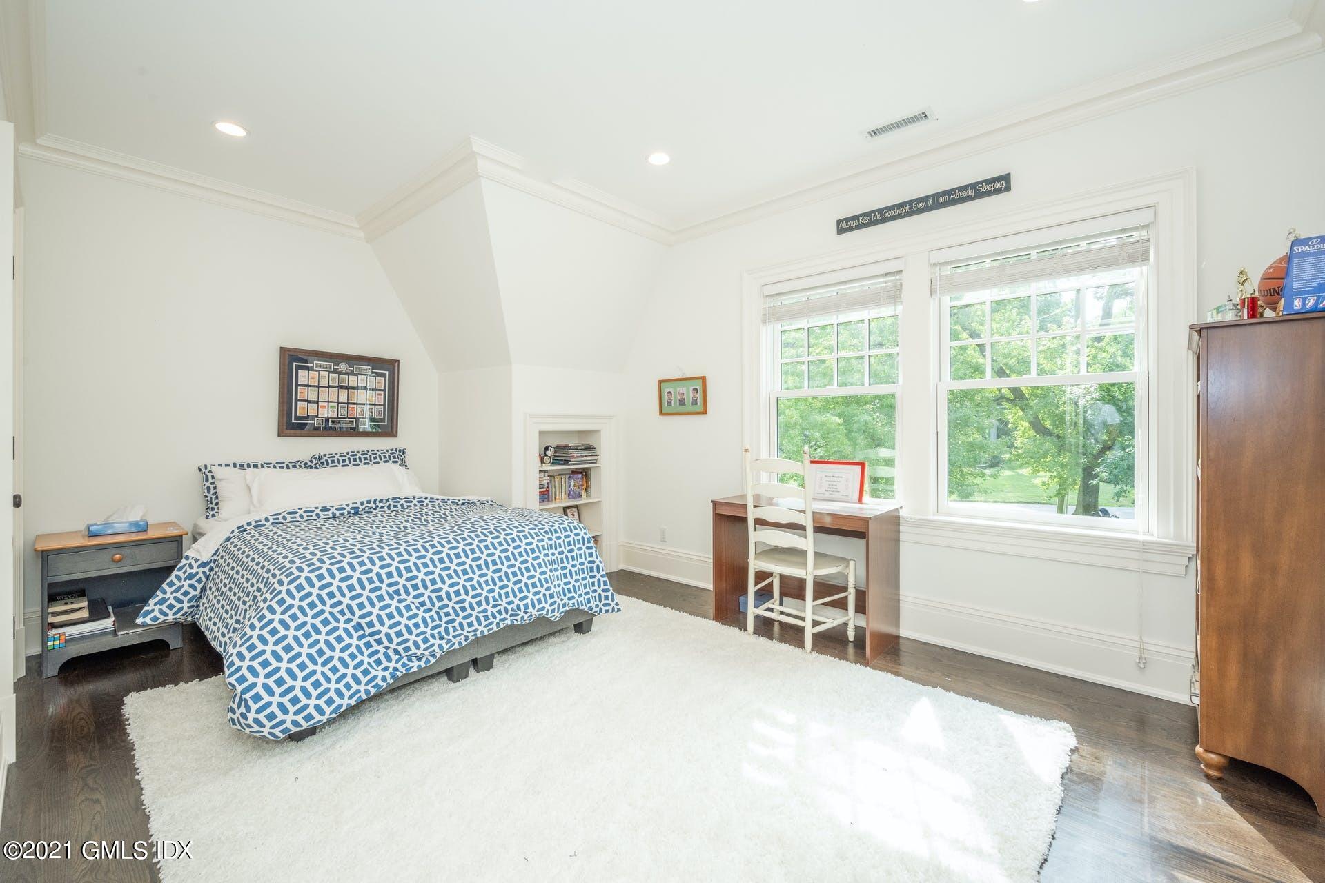 45 Willow Road Riverside, CT 06878 - Photo 25 of 38 a bedroom with a bed and a large window