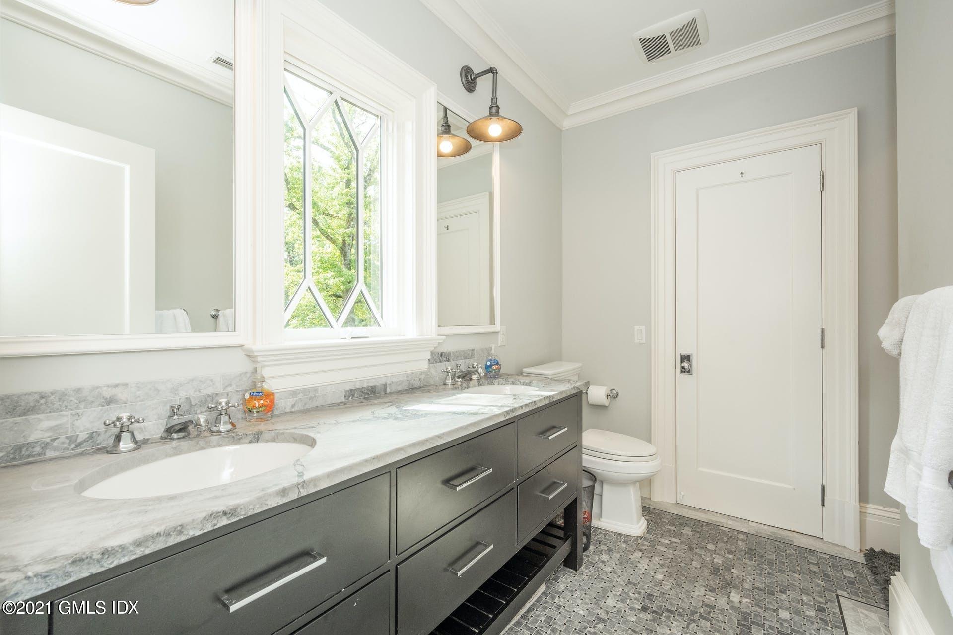 45 Willow Road Riverside, CT 06878 - Photo 27 of 38 a bathroom with a granite countertop sink a toilet and a mirror