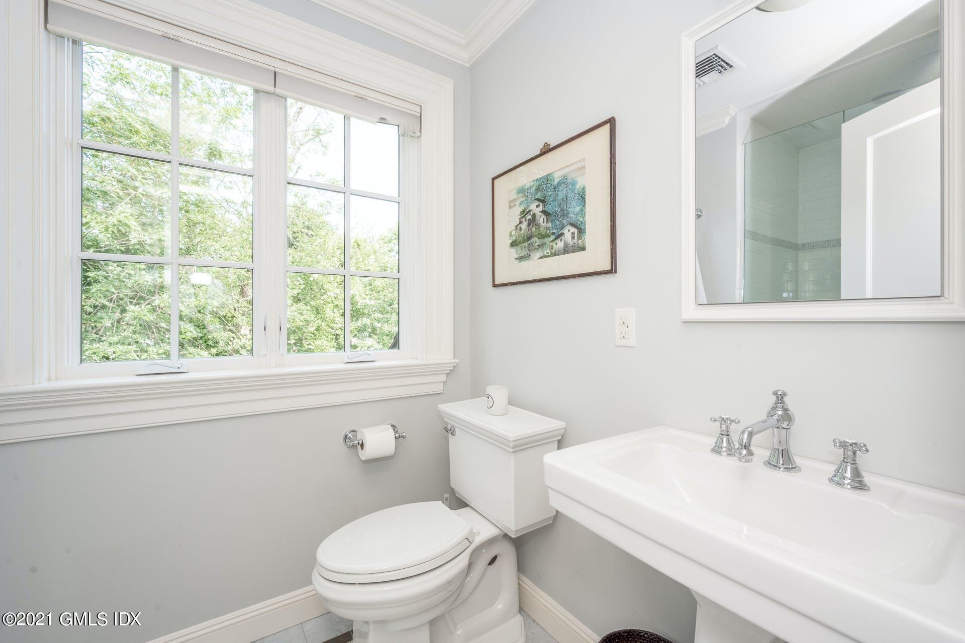 45 Willow Road Riverside, CT 06878 - Photo 28 of 38 a bathroom with a sink a toilet and a window