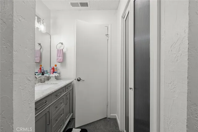 a bathroom with a sink vanity and a mirror