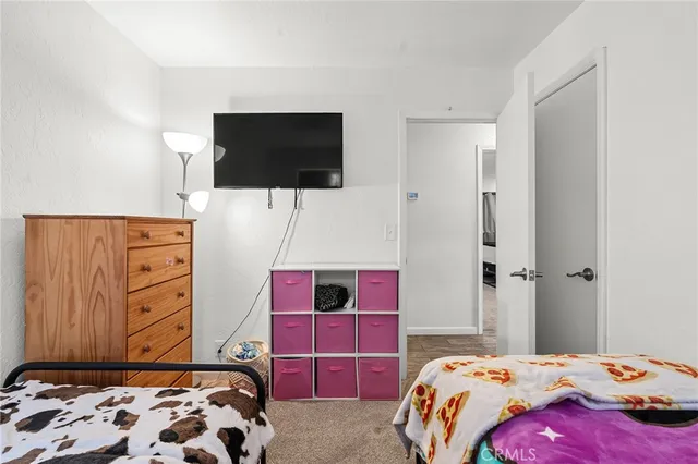 a bedroom with a bed and flat screen tv