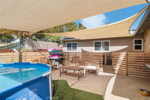 a view of a house with backyard sitting area and garden