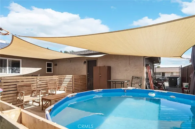a backyard of a house with outdoor seating
