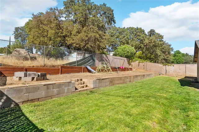 a house view with swimming pool and wooden fence