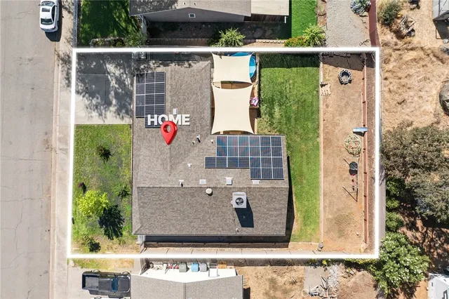 an aerial view of a house with a yard
