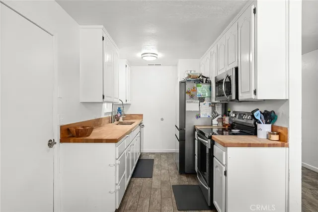 a kitchen with a sink stove and refrigerator
