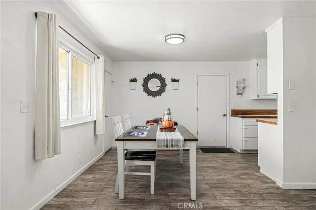 a view of kitchen with furniture and wooden floor