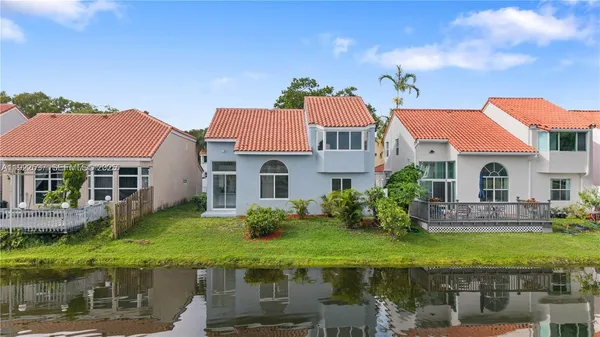 a front view of house with yard and lake view