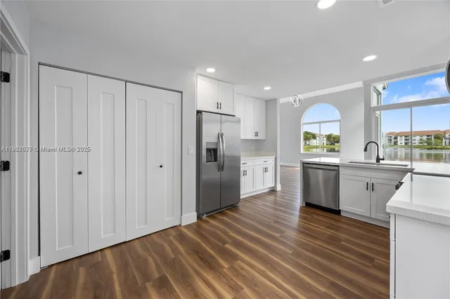 a kitchen with stainless steel appliances a refrigerator sink and cabinets
