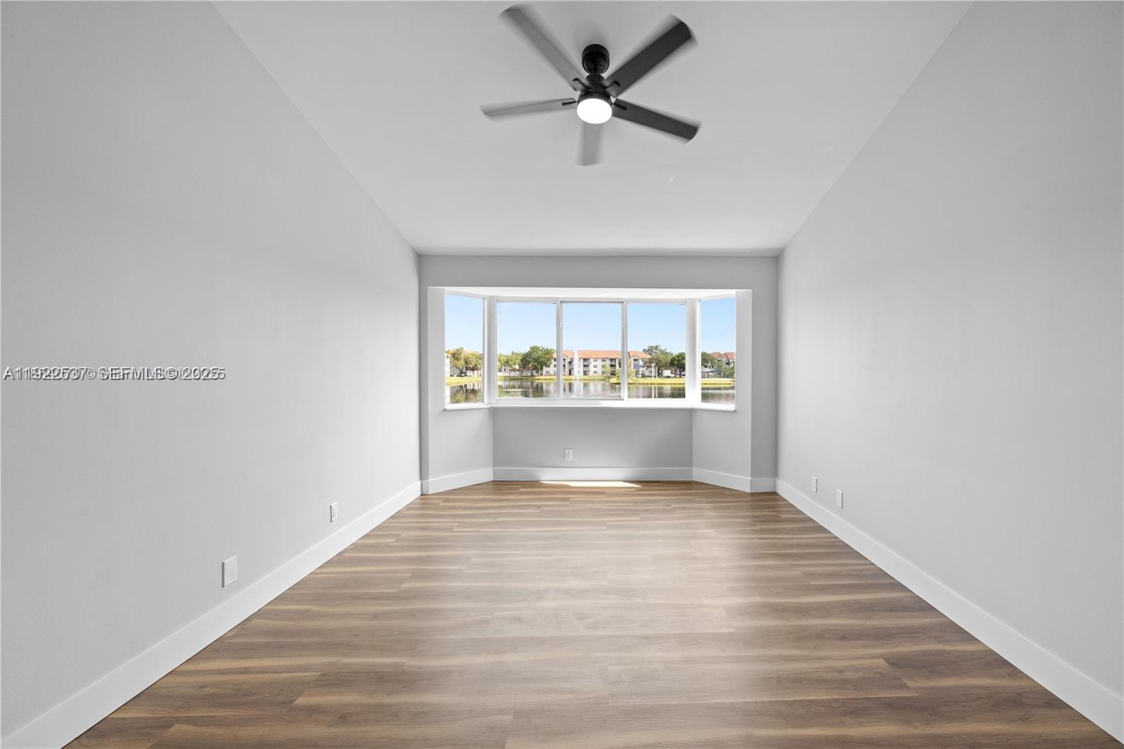 3835 Lombardy Street Hollywood, FL 33021 - Photo 13 of 25 a view of an empty room with window and wooden floor