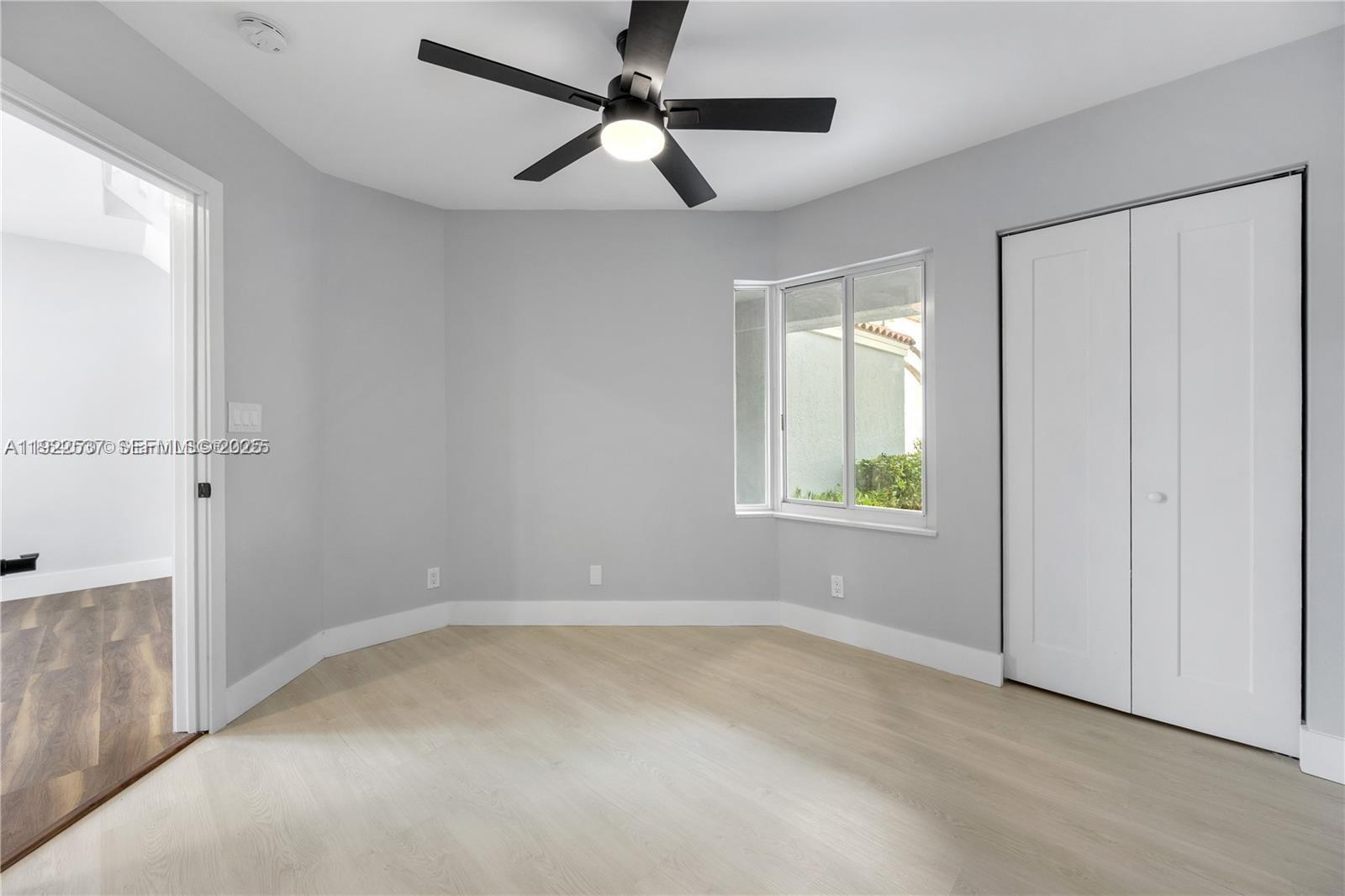 3835 Lombardy Street Hollywood, FL 33021 - Photo 18 of 25 an empty room with windows and fan