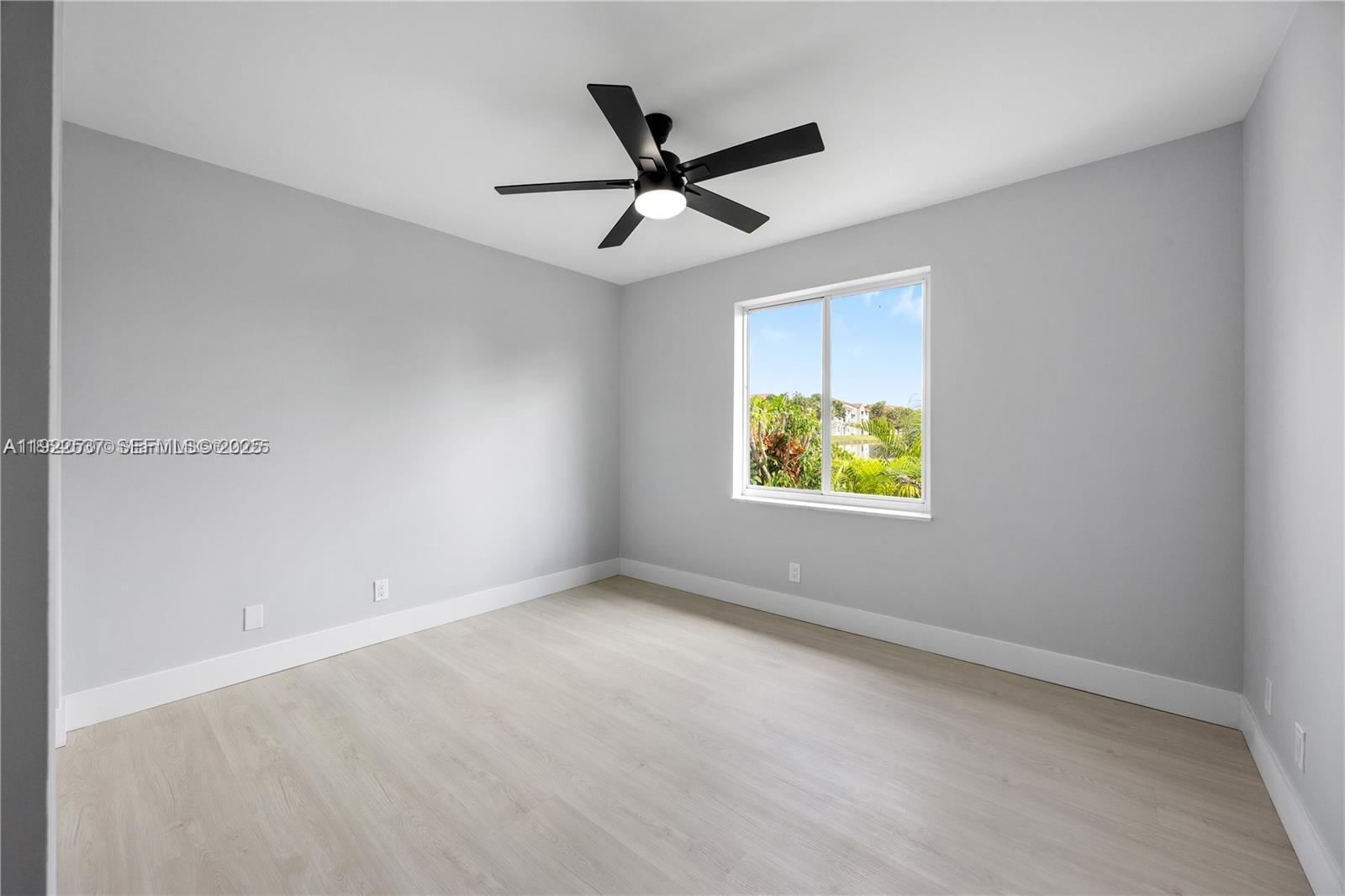 3835 Lombardy Street Hollywood, FL 33021 - Photo 19 of 25 an empty room with ceiling fan and window