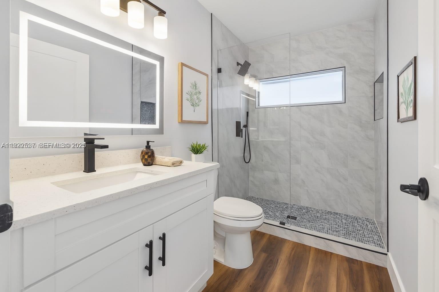 3835 Lombardy Street Hollywood, FL 33021 - Photo 21 of 25 a bathroom with a sink a toilet and shower