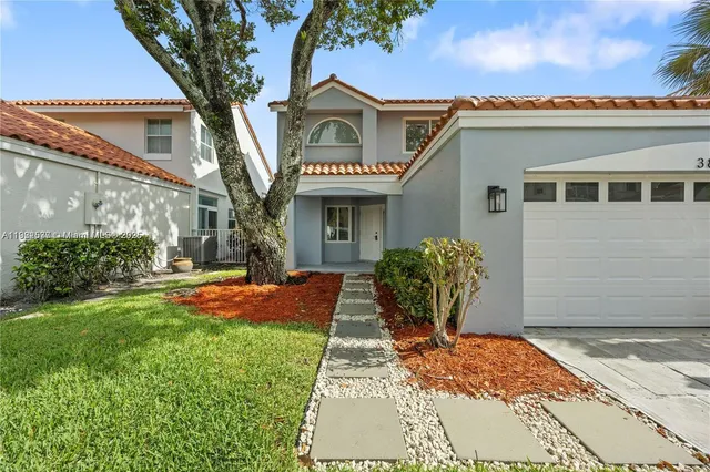 a front view of a house with garden