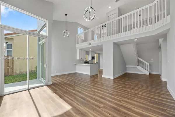 a view of an entryway with wooden floor