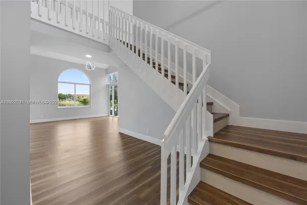a view of entryway and hall with wooden floor