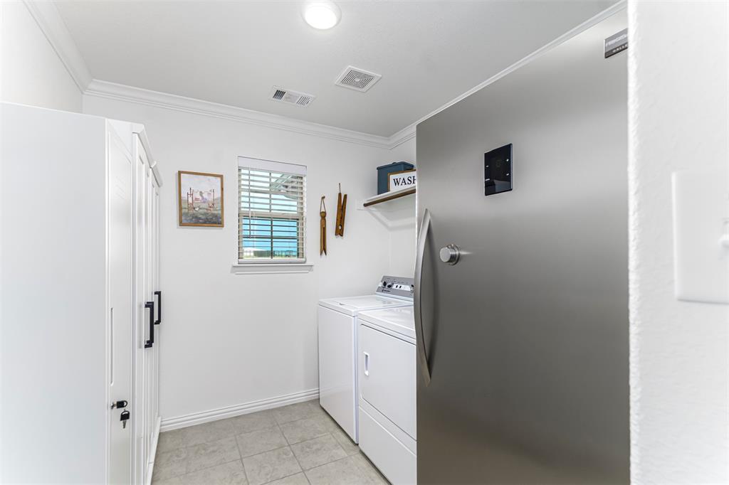 129 Springwood Ranch Loop Springtown, TX 76082 - Photo 20 of 29 White utility room with crown molding, tiled flooring, and a single window with blinds
