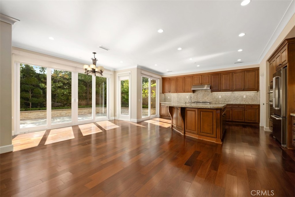 61 Triana Irvine, CA 92618 - Photo 11 of 56 a living room with stainless steel appliances kitchen island granite countertop wooden floors and a large window