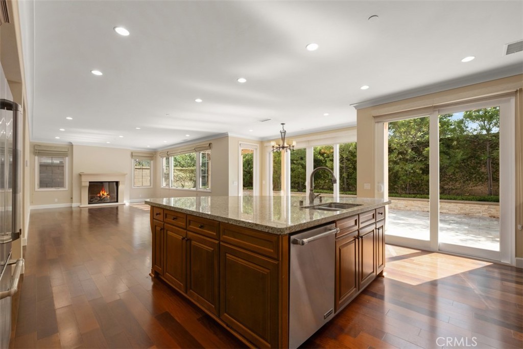 61 Triana Irvine, CA 92618 - Photo 14 of 56 a kitchen with stainless steel appliances granite countertop sink stove and wooden cabinets