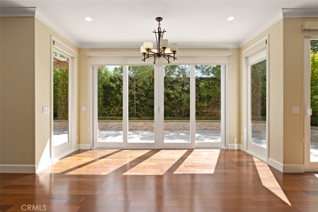 61 Triana Irvine, CA 92618 - Photo 16 of 56 a room with a balcony a ceiling fan and wooden floor