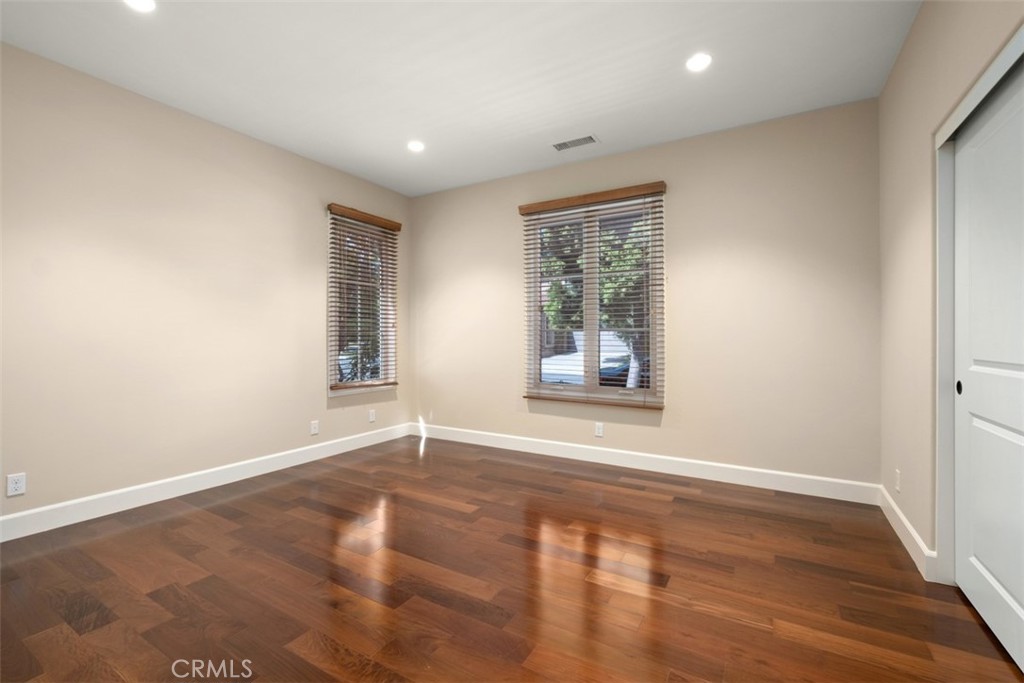 61 Triana Irvine, CA 92618 - Photo 17 of 56 an empty room with wooden floor and windows
