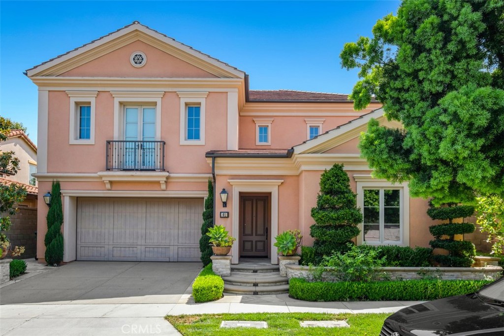 61 Triana Irvine, CA 92618 - Photo 2 of 56 a front view of a house with garden and garage