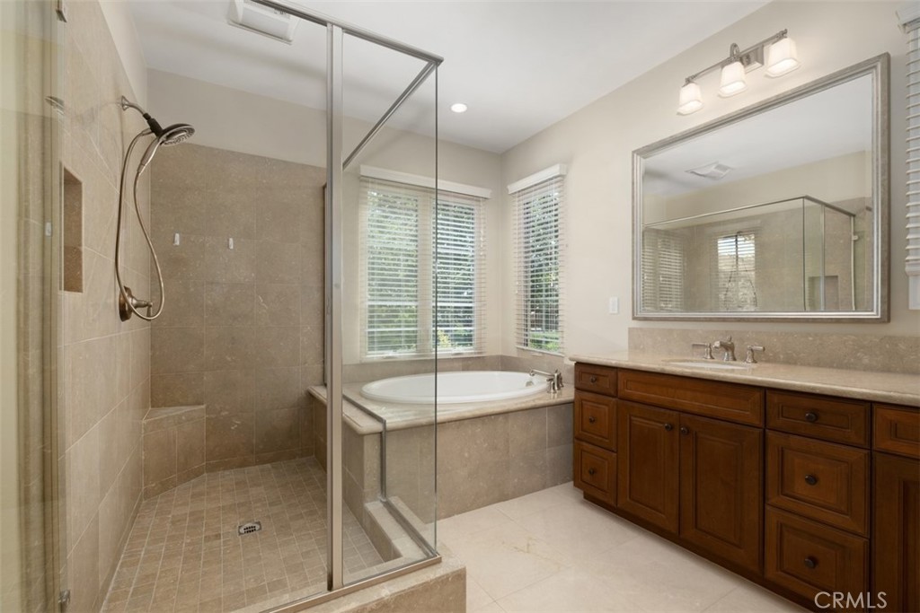 61 Triana Irvine, CA 92618 - Photo 23 of 56 a bathroom with a tub sink shower and mirror